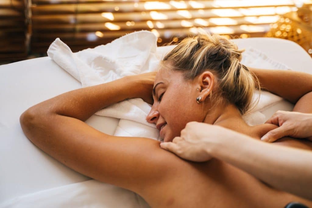 pexels-photo-6560265 Woman enjoying a relaxing massage in a serene spa setting, promoting wellness.