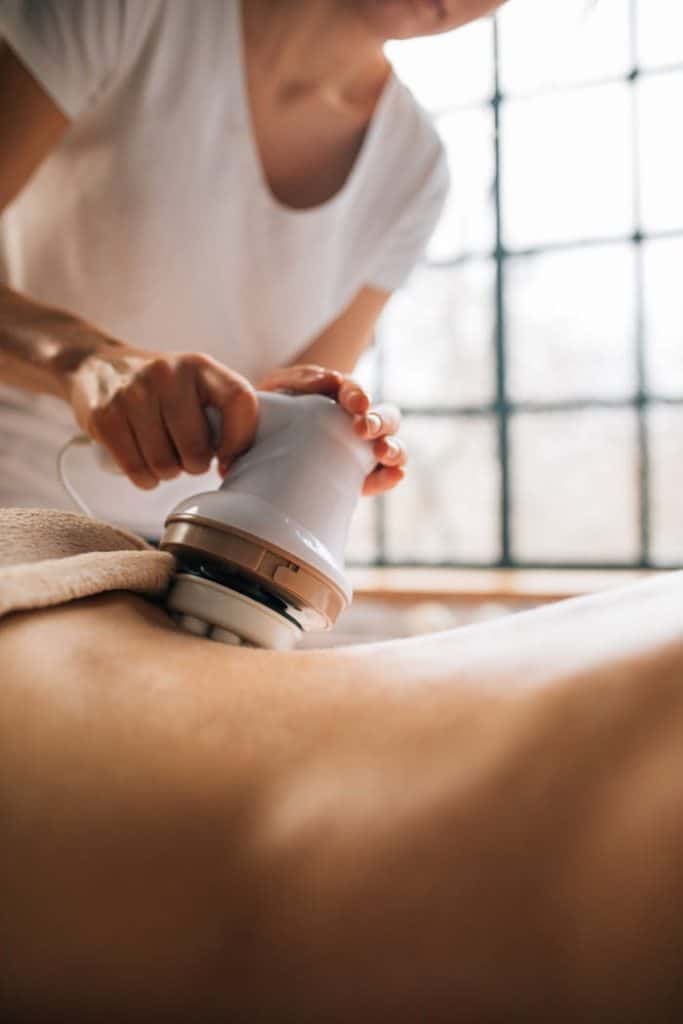 pexels-photo-6628648 Relaxing body massage therapy session using an innovative electronic device indoors.